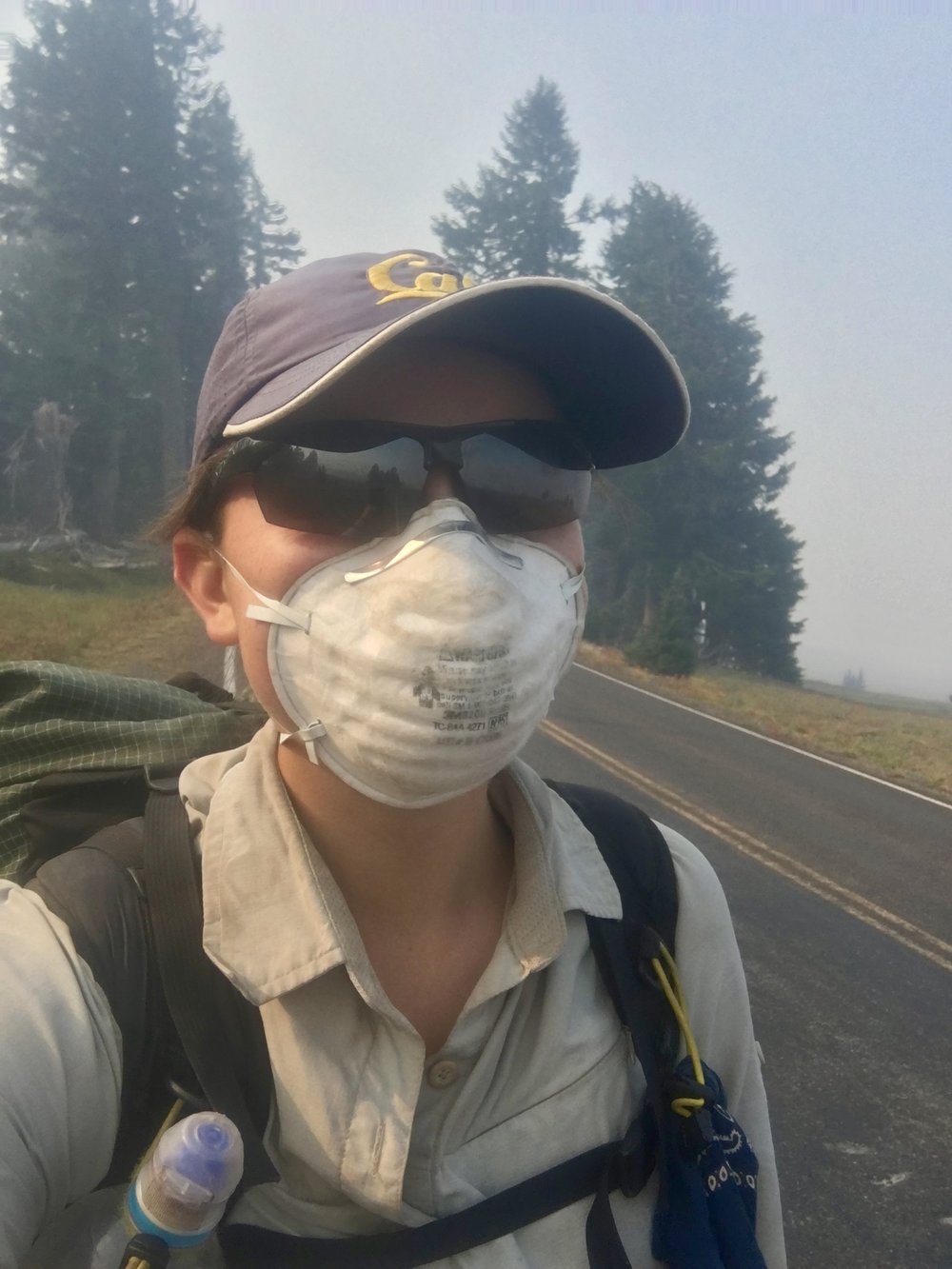 Road walking around Crater Lake with a smoke mask. We didn’t get to see the lake that day because the bowl was completely filled with smoke from nearby wildfires.